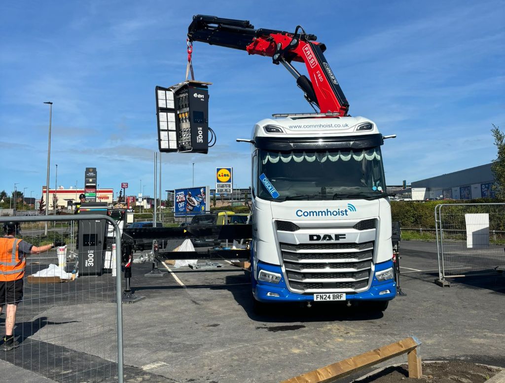 Charger installation at Cross Hands — crane lifting Alpitronic 300kW unit into position during build programme